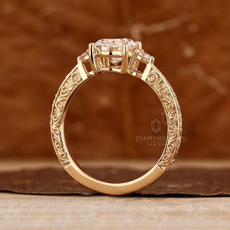 Vintage three diamond ring with hand engraved filigree details.