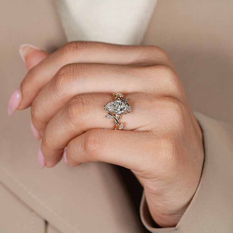 Pear cut diamond ring with five claw prongs.
