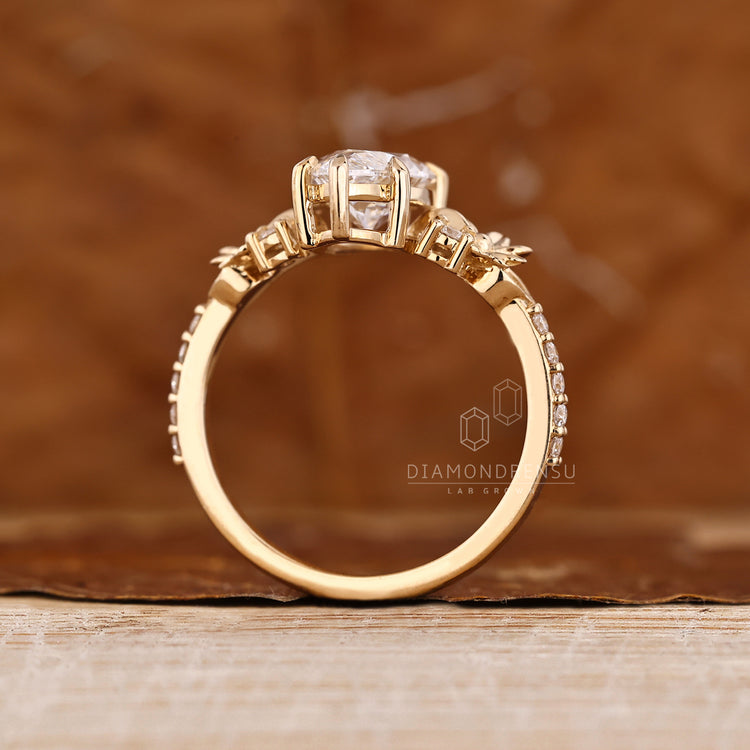 Marquise engagement ring with round cut pave band and accents.