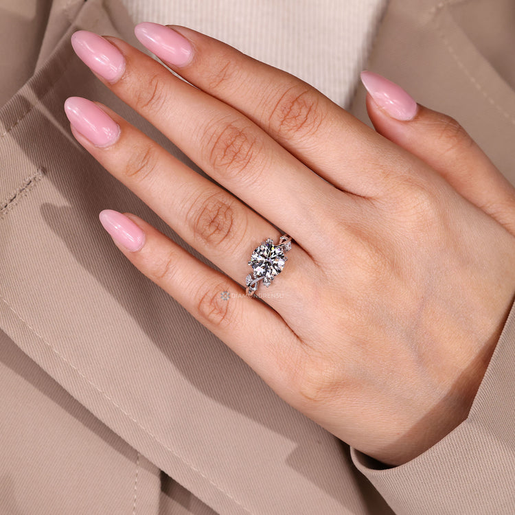 Round center stone with four leaf style prong setting.