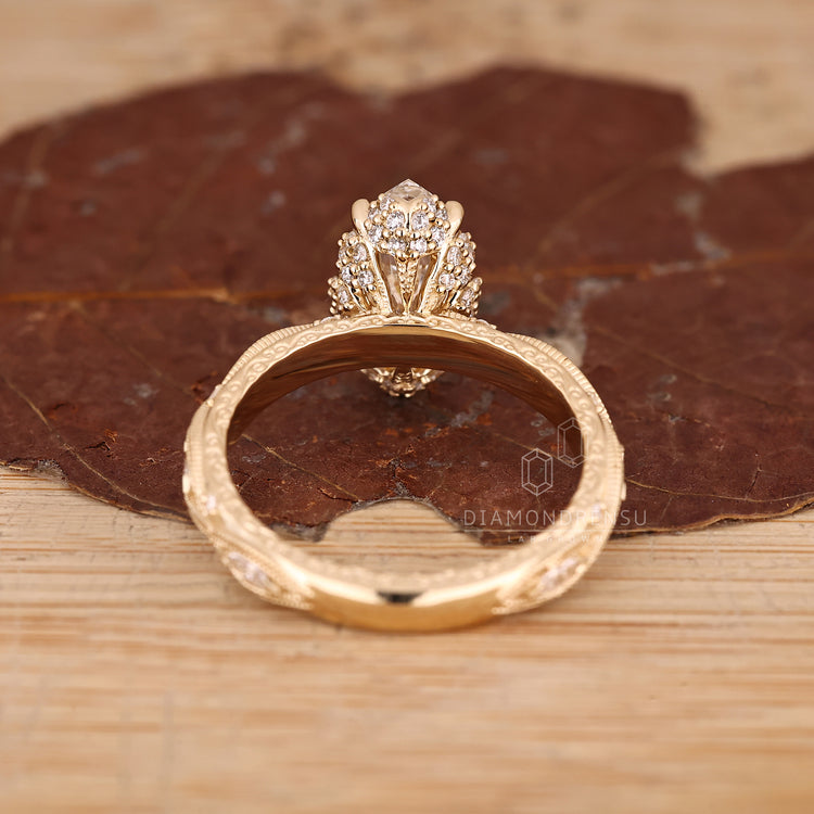 Round cut hidden accent on vintage inspired Marquise Diamond Ring.
