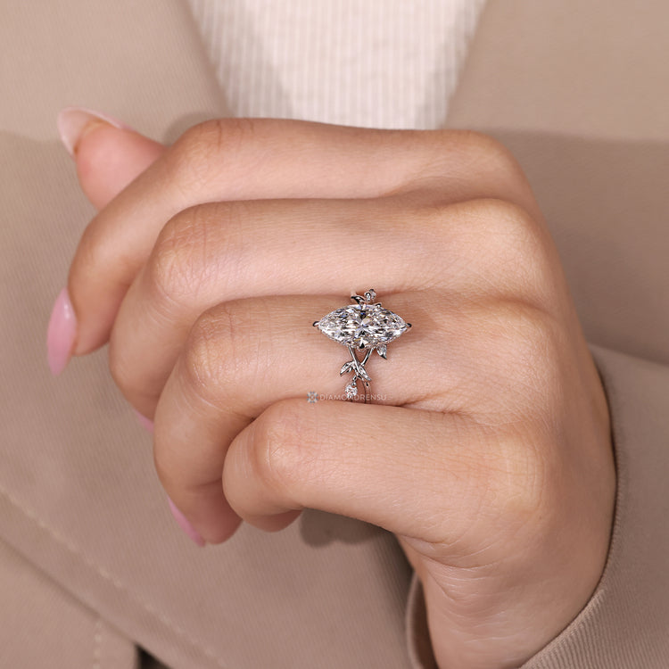 Nature inspired ring with marquise diamond and four claw prongs.