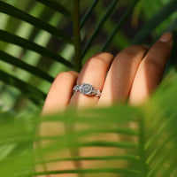 Portuguese cut diamond ring set in four prongs with marquise side stones.