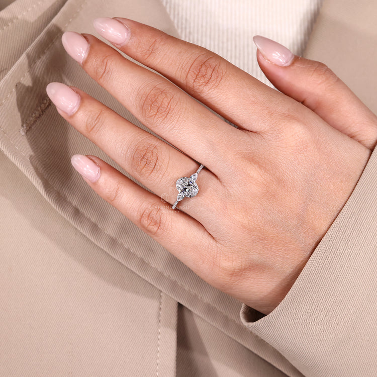 Oval cut diamond ring with pave band and halo.