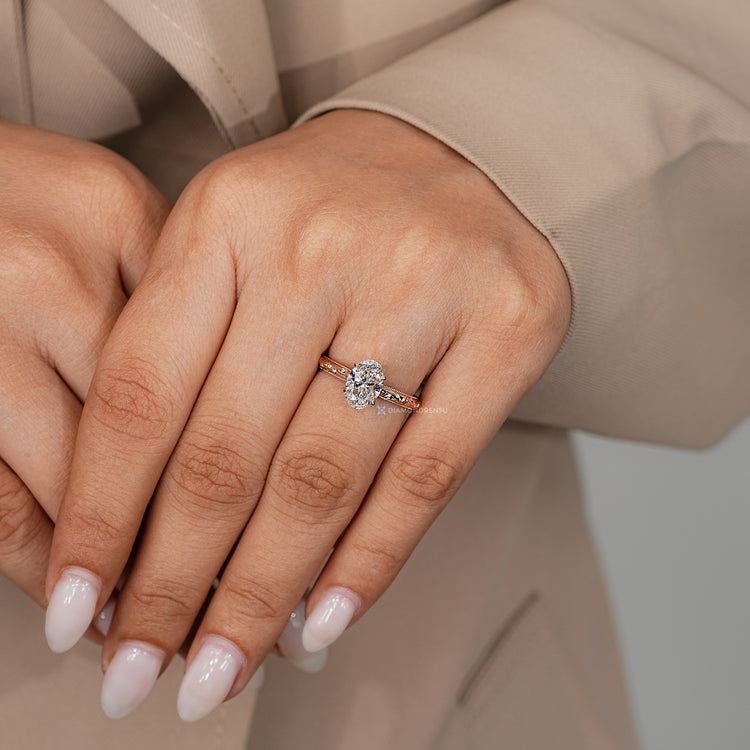 Oval ring with a cathedral setting and four claw prongs.