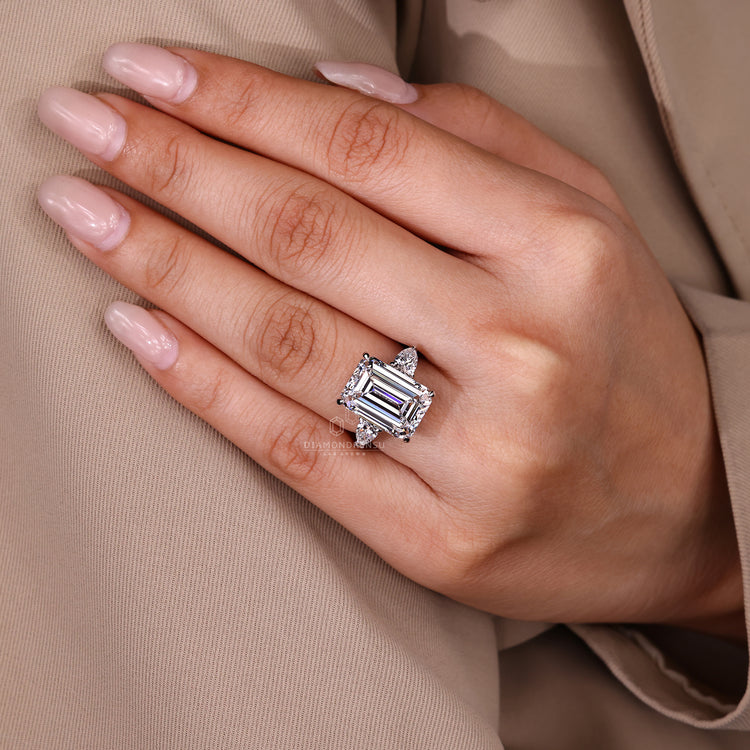 Emerald cut lab grown diamond ring with pear side stones.
