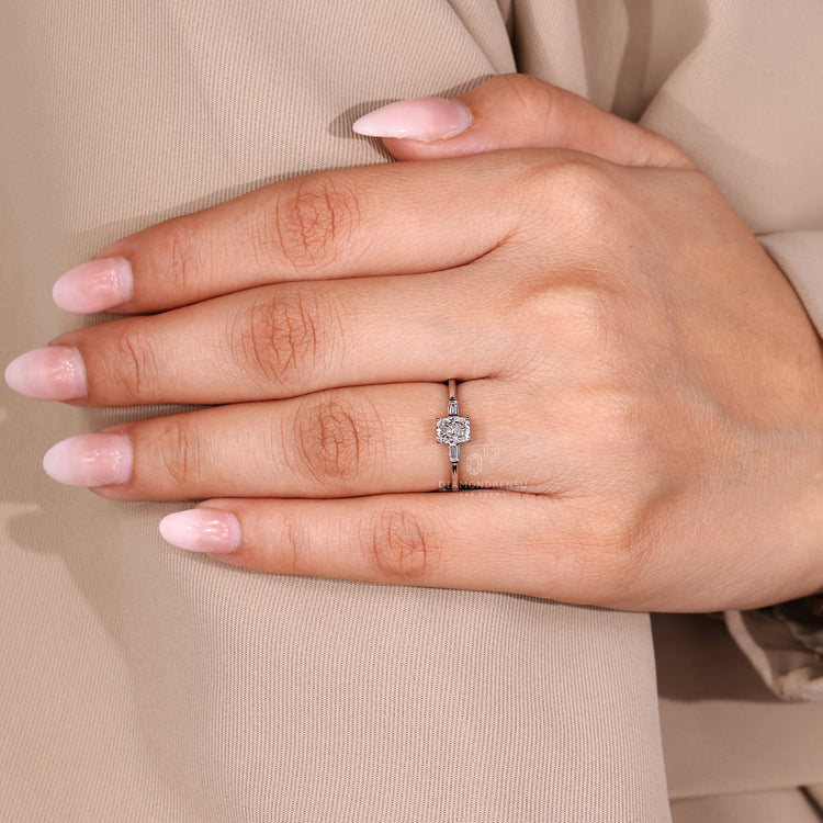 Three diamond ring with radiant center diamond and four prong setting.