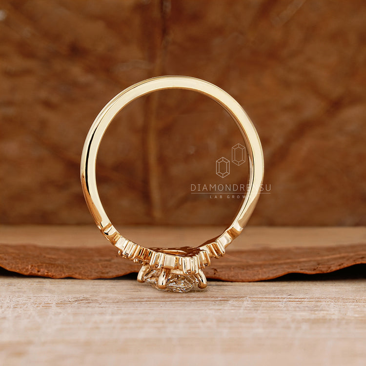 Handmade marquise diamond ring with round side stone details.