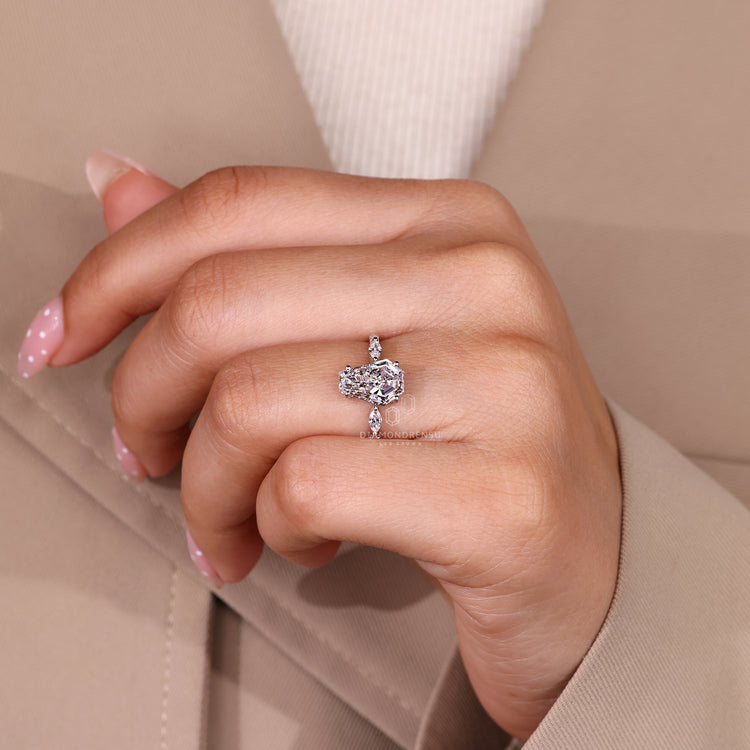 Coffin center stone ring with marquise side stone details.