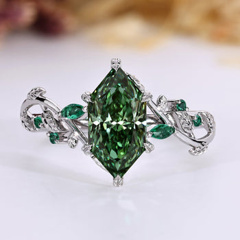 Dutch marquise diamond ring with green center stone and green emerald side stones.