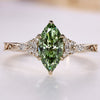 Art Deco diamond ring with a green marquise center stone.