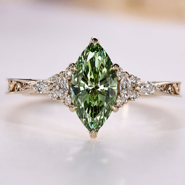 Art Deco diamond ring with a green marquise center stone.