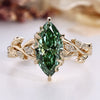 Nature inspired engagement ring with green marquise center stone.