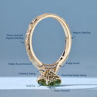 Green oval center stone with a cathedral setting and bridge accent with round stones.