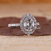 Cushion old mine cut center stone with cathedral style band.
