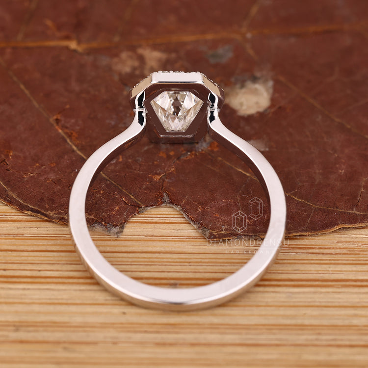 Handmade coffin ring with bezel setting and halo details.