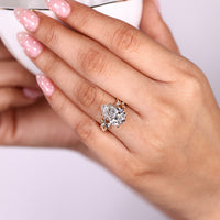 Nature inspired pear shaped diamond ring with four leaf style prong setting.
