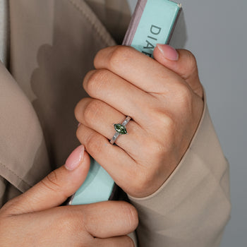Green Dutch marquise diamond ring in a solitaire style.