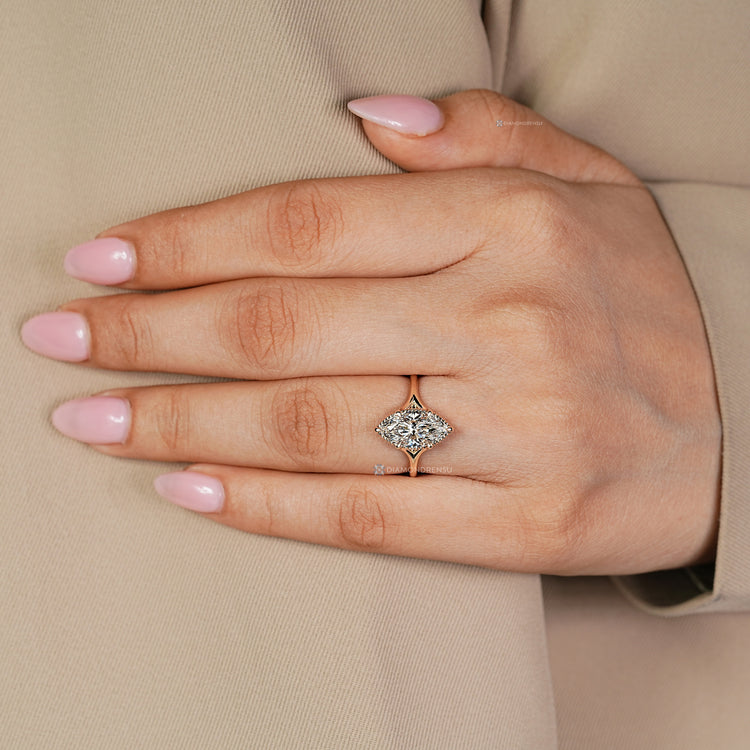 Marquise diamond ring with a solitaire style and split shank.