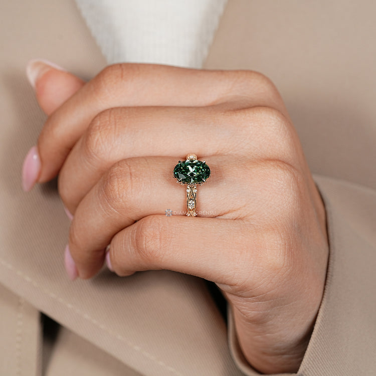 Oval cut diamond ring with milgrain detailing and round side stones.