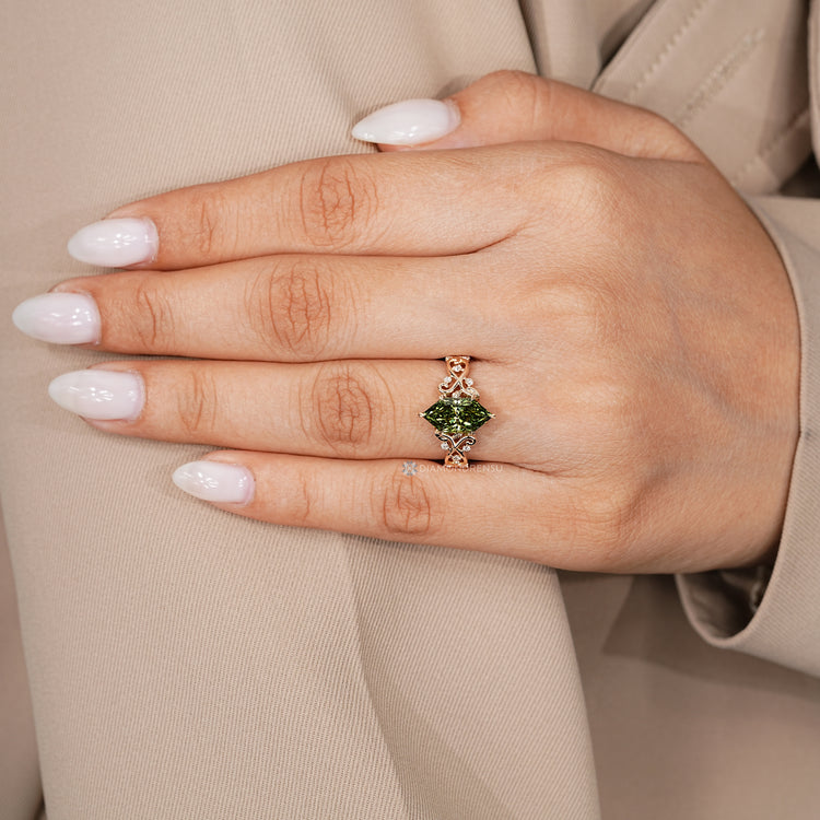 Dutch marquise diamond ring with round side stones and leaf style prongs.