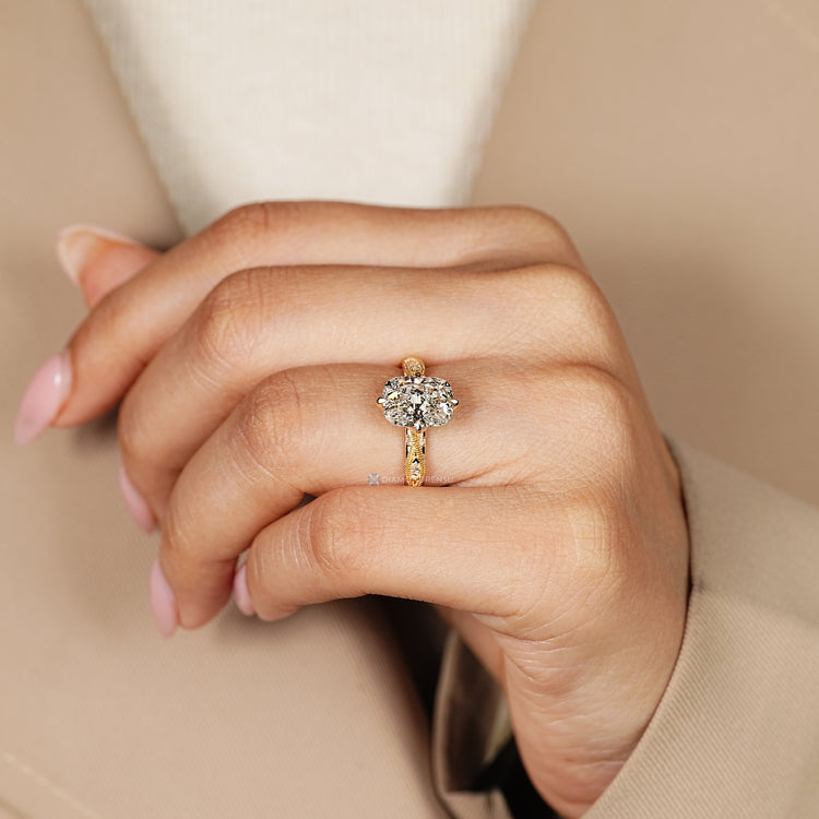 Cushion cut diamond ring with a compass prong setting.