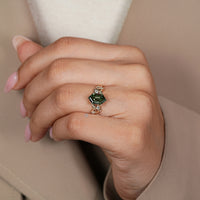 Six leaf style prong setting secures the green center stone.
