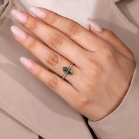 Dutch marquise green diamond ring with solitaire design.