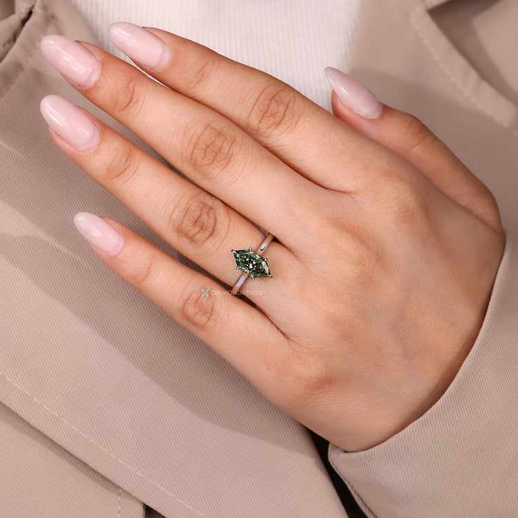 Dutch marquise green diamond ring with solitaire design.