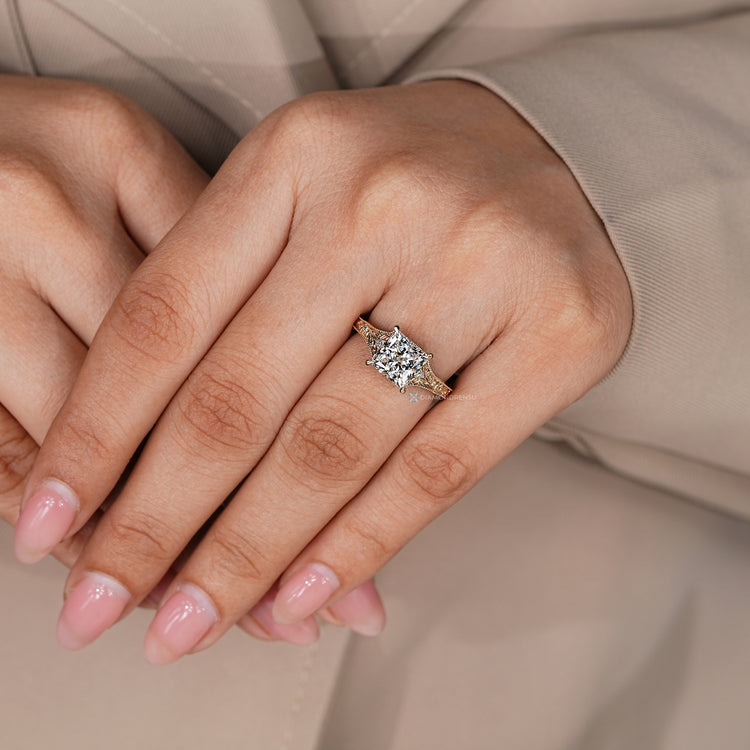 Art Deco engagement ring with a princess cut and round side stones.