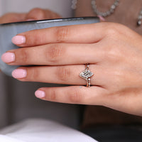Compass prong setting secures the marquise center stone.