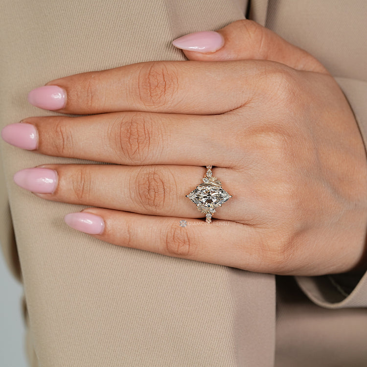 Diamondrensu presents a marquise cut diamond ring with marquise side stones.