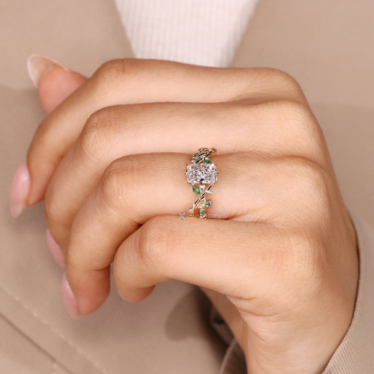 Nature inspired engagement ring with green emerald gemstones.