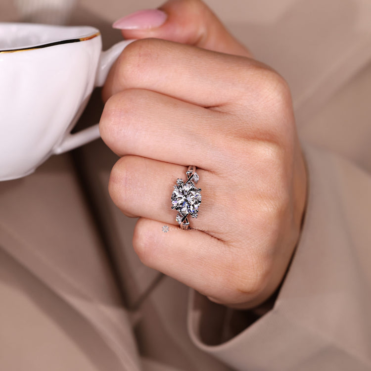 Marquise and round side stones with four leaf style prong setting.