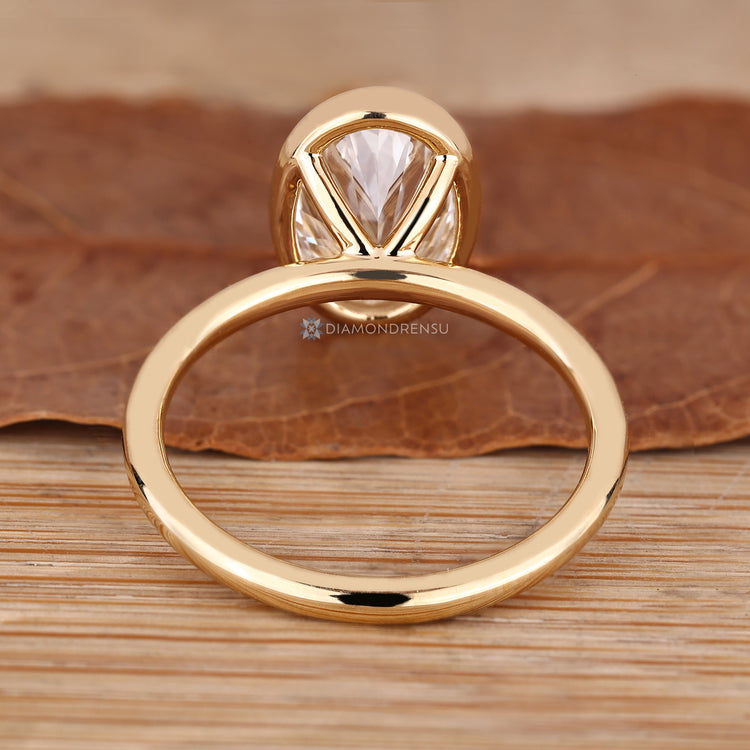Oval cut bezel diamond ring.