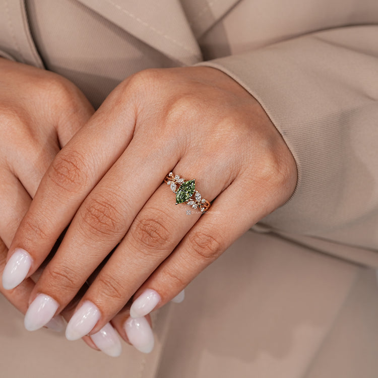Diamondrensu green marquise diamond ring with round side stones.