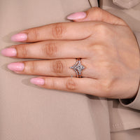 Six claw prong setting secures the marquise center stone.