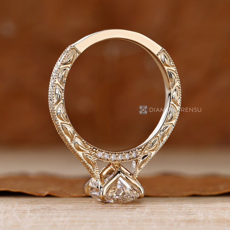 Art Deco engagement ring with bridge accent with round stone and cathedral setting.