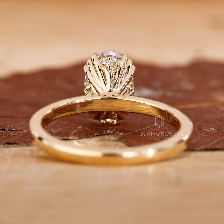 Handmade oval engagement ring with triple prong design.
