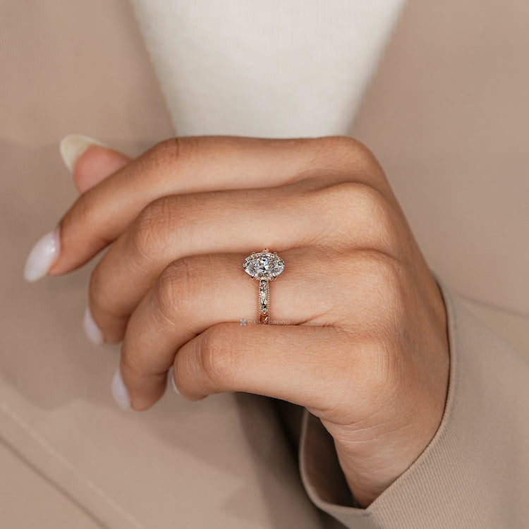 Oval ring with round stone bridge accents and milgrain details.
