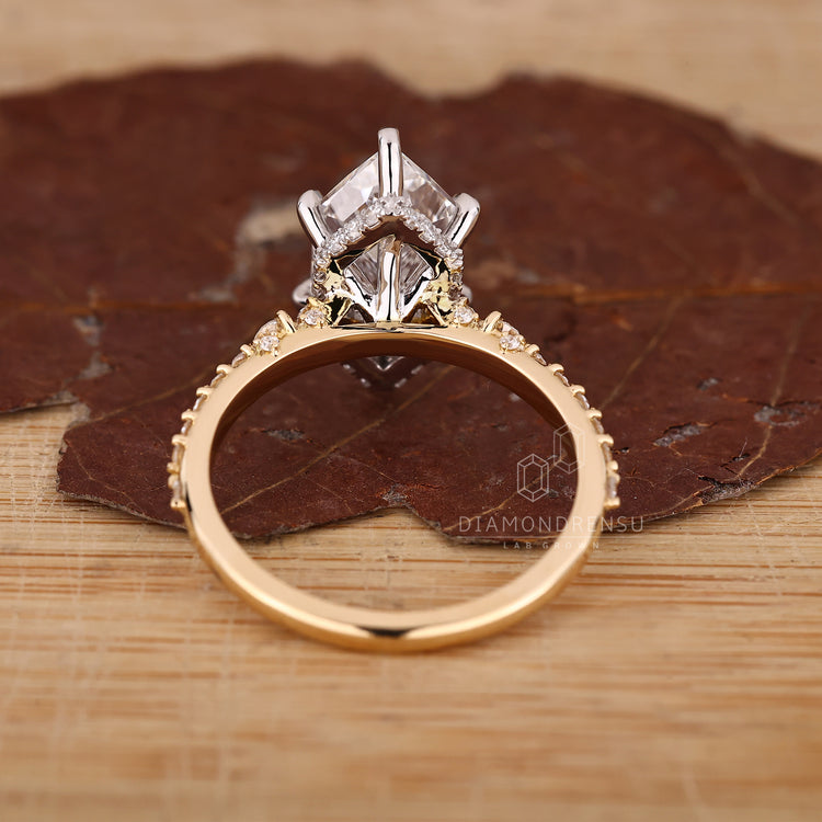 Dutch marquise ring with hidden halo setting and round cut pave accents.