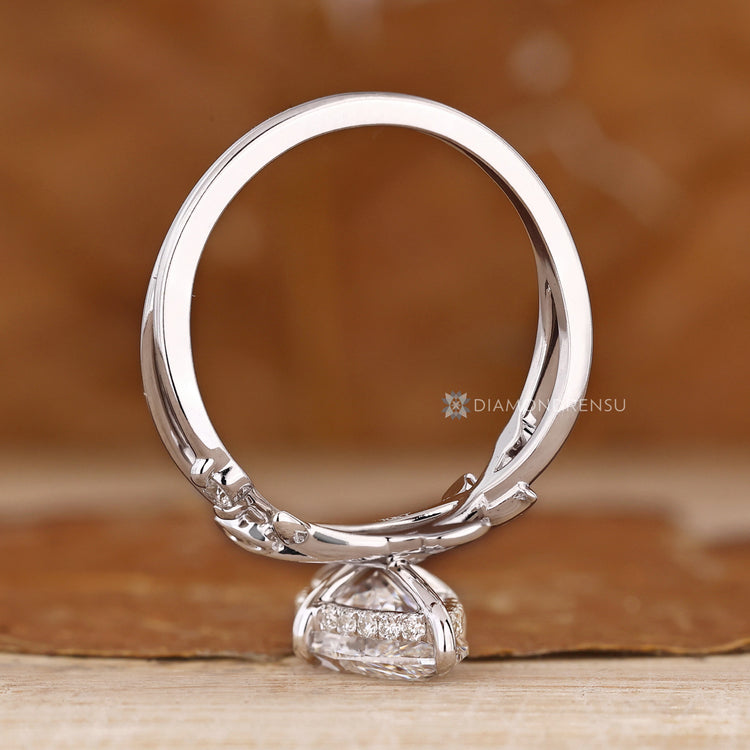 Marquise engagement ring with round hidden halo accents.