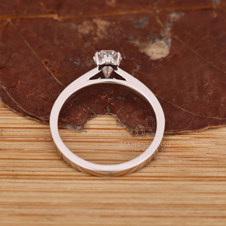 Lab grown diamond ring with coffin cut center and round accents.