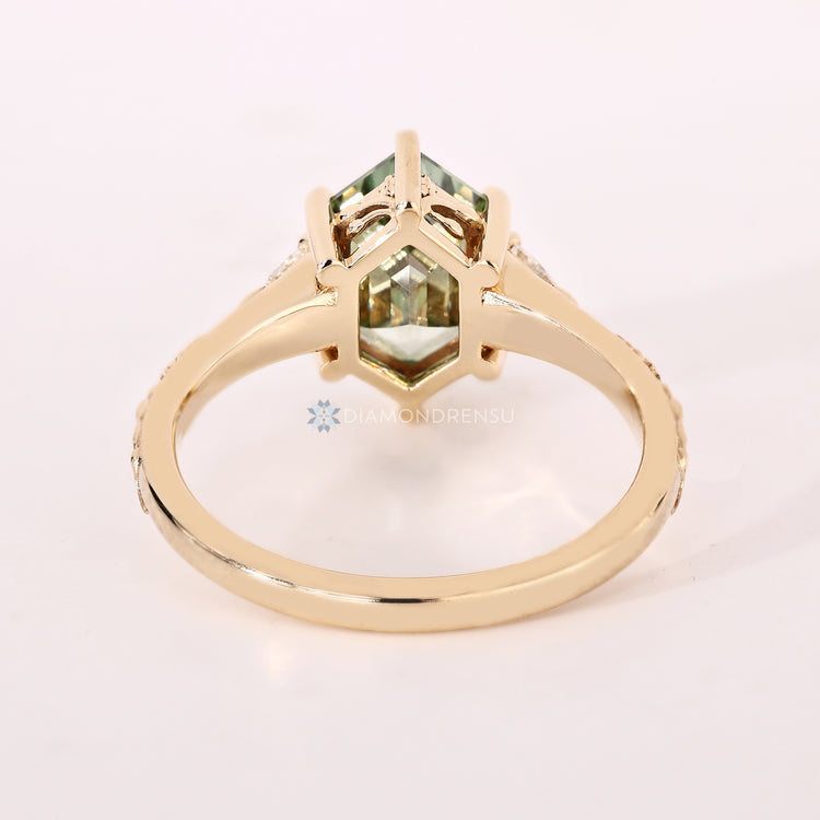 Green Art Deco diamond ring with a hexagon shape.
