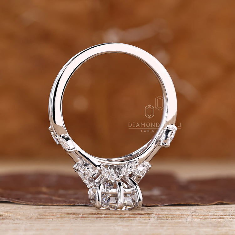Coffin cut diamond ring with marquise side stones and prong design.