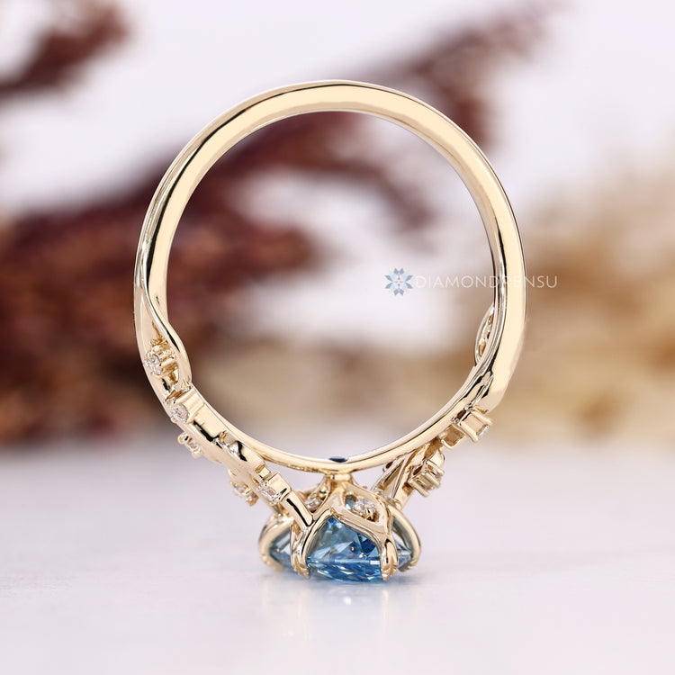 Diamondrensu blue marquise engagement ring with round side stones.