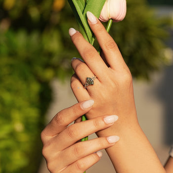 Marquise ring with ornate vintage scrollwork shank and milgrain details.