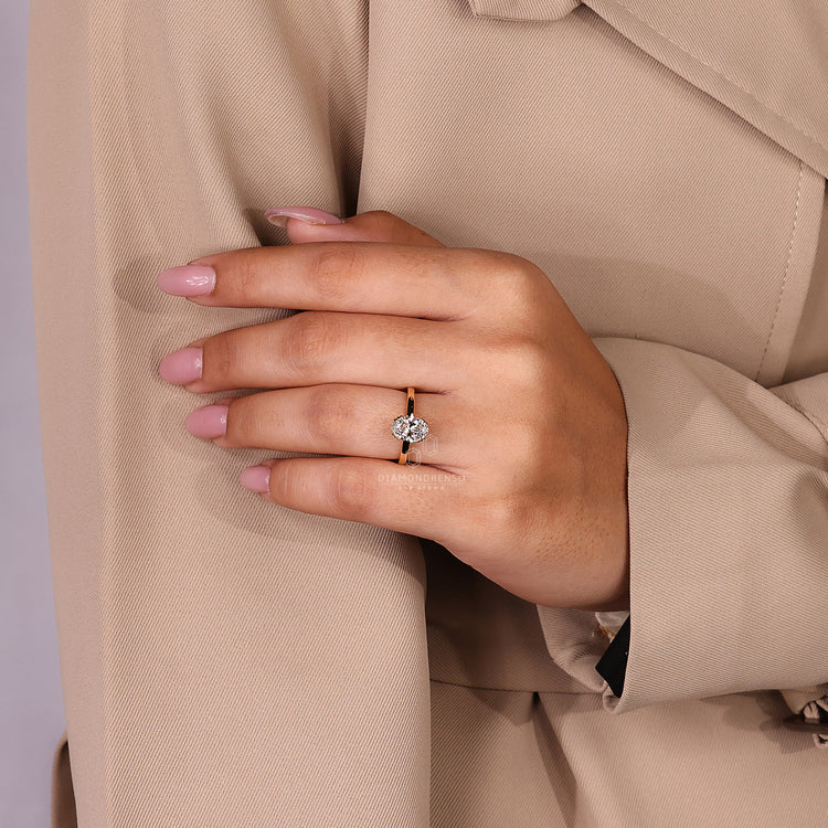 Oval cut diamond ring with round hidden diamond details.