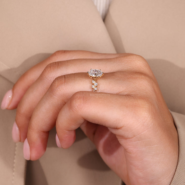 Oval ring with six claw prong and round side stones.
