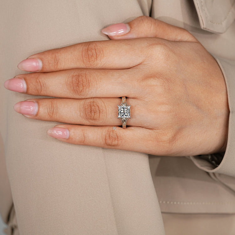 Vintage style princess cut engagement ring with round side stones.